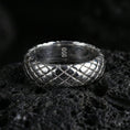 Load image into Gallery viewer, Polished silver woven texture band ring on volcanic stone, sharp macro product photo emphasizing clean reflections and crisp crosshatch detail.
