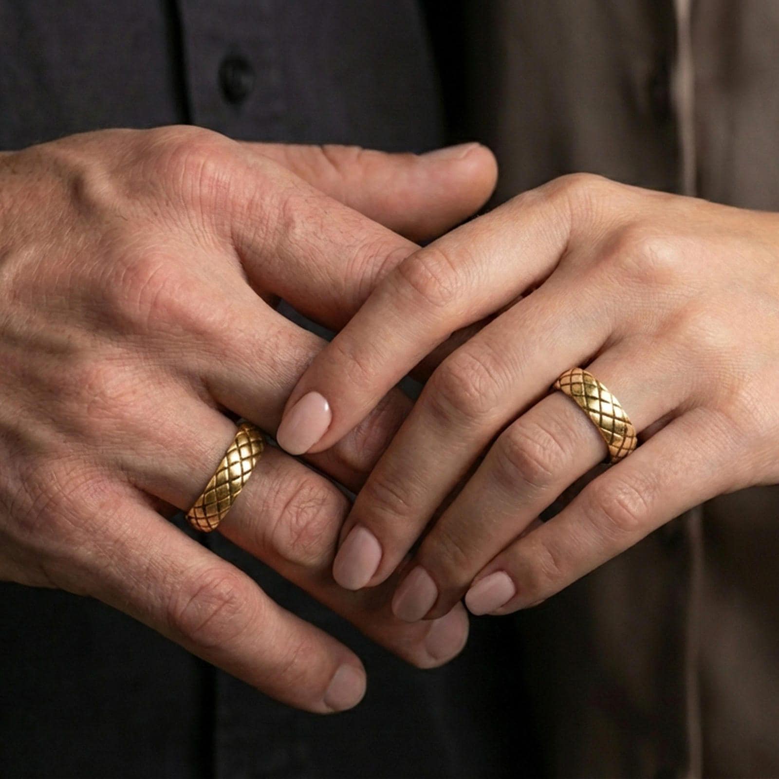 Gold plated woven texture band ring worn on a finger, lifestyle wear image capturing warm reflective finish and the woven grid pattern clearly.