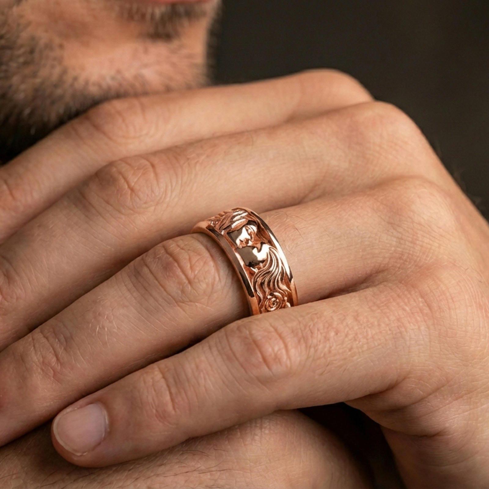 Rose gold plated lovers face ring worn on a finger, lifestyle wear photo featuring elegant rose tone and detailed portrait engraving for a refined gift look.