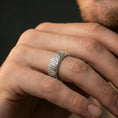 Load image into Gallery viewer, Polished silver wave pattern band ring worn on a finger, lifestyle photo highlighting modern shine, defined wave details, and clean minimal presence.
