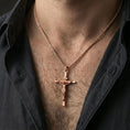 Load image into Gallery viewer, Rose gold plated crucifix pendant worn on the neck, lifestyle image showcasing warm rose tone, detailed relief, and refined giftable aesthetic.
