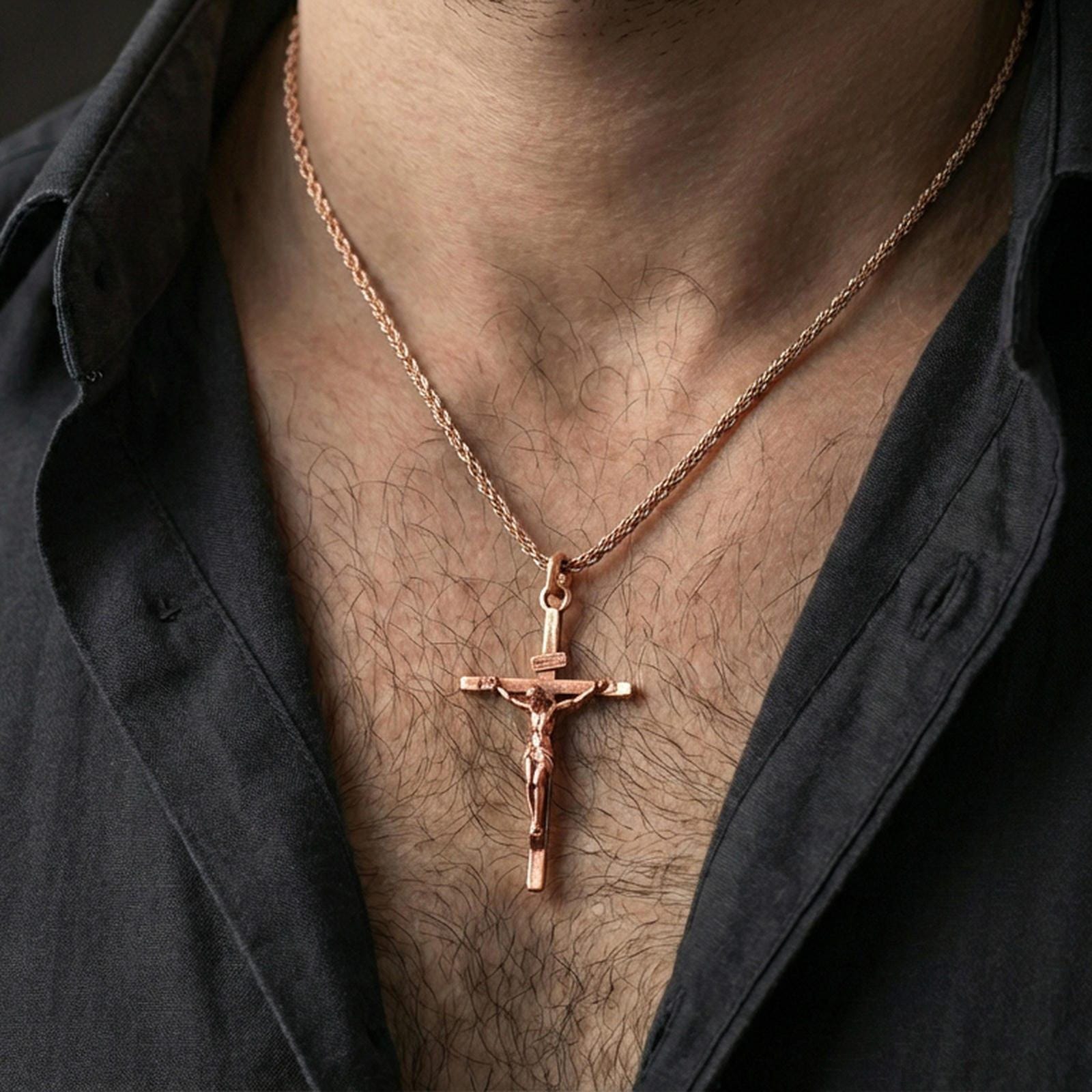 Rose gold plated crucifix pendant worn on the neck, lifestyle image showcasing warm rose tone, detailed relief, and refined giftable aesthetic.