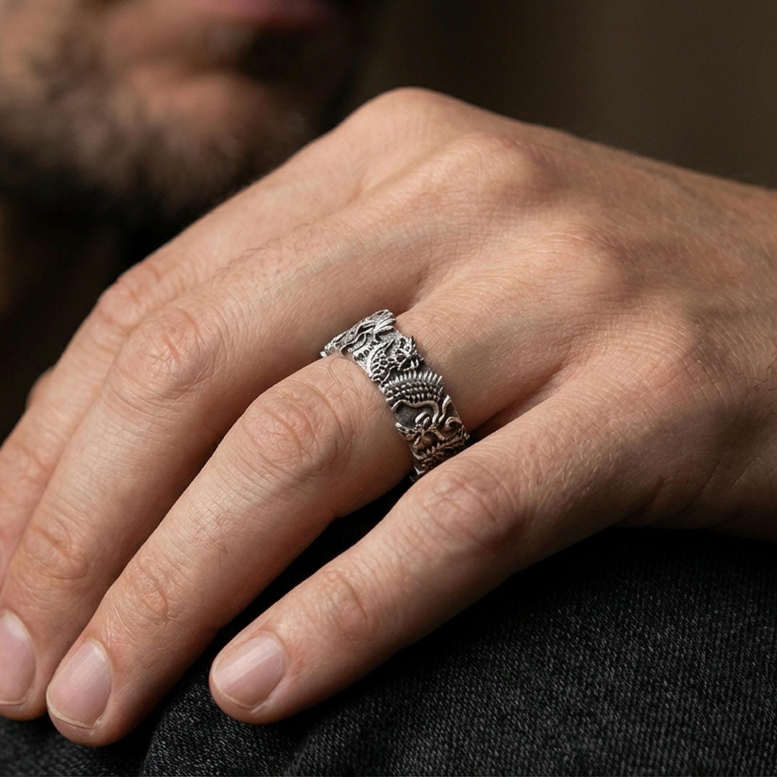 Oxidized sterling silver Japanese dragon band ring worn on the finger, lifestyle photo focusing on bold contrast, textured scales, and statement biker styling.