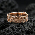 Load image into Gallery viewer, Rose gold plated Japanese dragon band ring on volcanic stone, elegant macro shot capturing soft rose reflections, detailed engraving, and dimensional relief.
