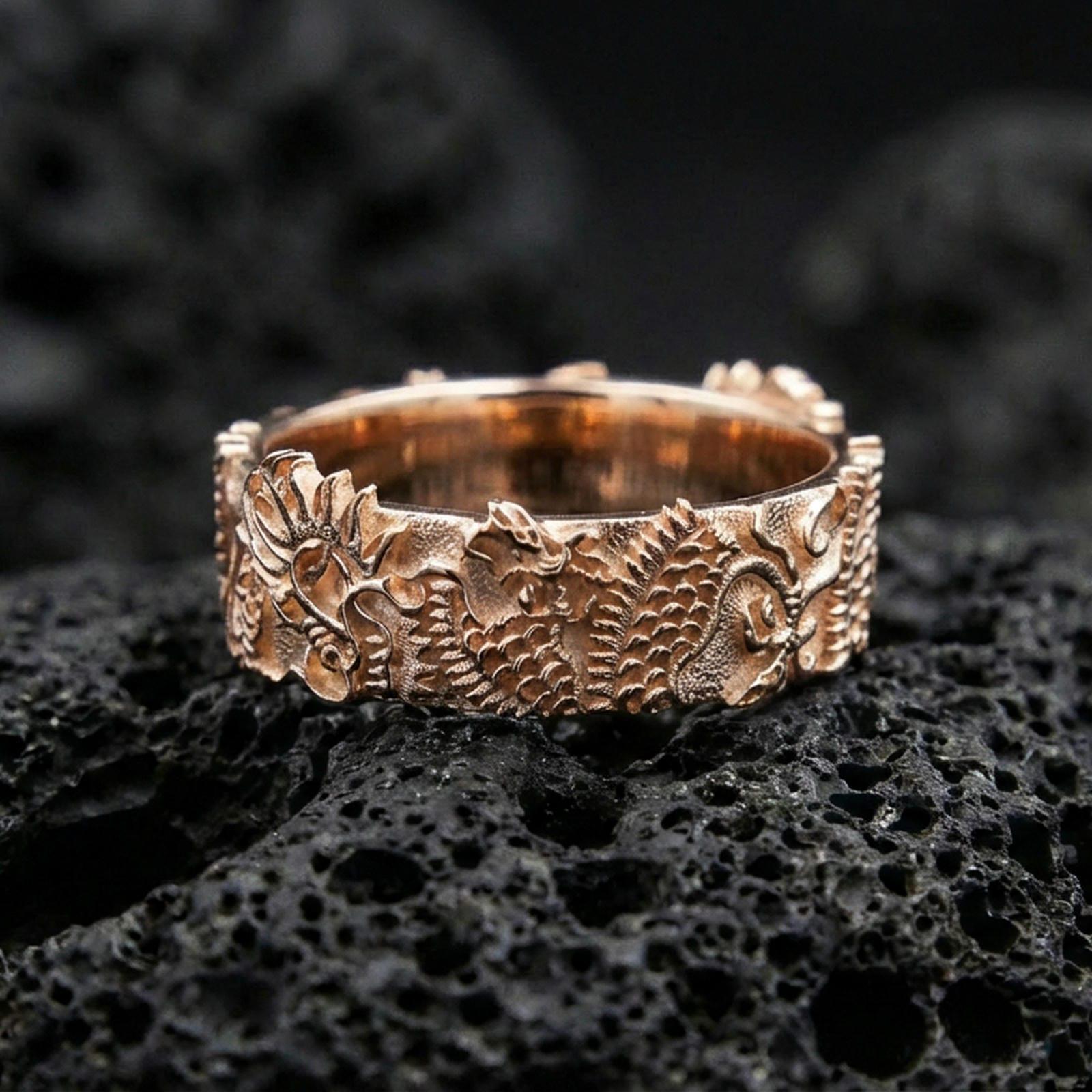 Rose gold plated Japanese dragon band ring on volcanic stone, elegant macro shot capturing soft rose reflections, detailed engraving, and dimensional relief.