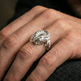 Load image into Gallery viewer, Polished silver koi fish wrap ring worn on the finger, lifestyle image highlighting bright shine, refined contours, and modern everyday styling.
