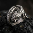 Load image into Gallery viewer, Oxidized sterling silver koi fish wrap ring on volcanic stone, macro close-up highlighting the coiled body, deep scale texture, and antique contrast shadows.
