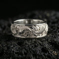 Load image into Gallery viewer, Polished silver koi fish band ring on volcanic stone, crisp macro shot highlighting smooth edges, bright shine, and detailed koi scale texture.
