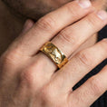 Load image into Gallery viewer, Gold plated lion band ring worn on the finger, lifestyle photo emphasizing luxury warmth, statement presence, and gift-ready appeal.
