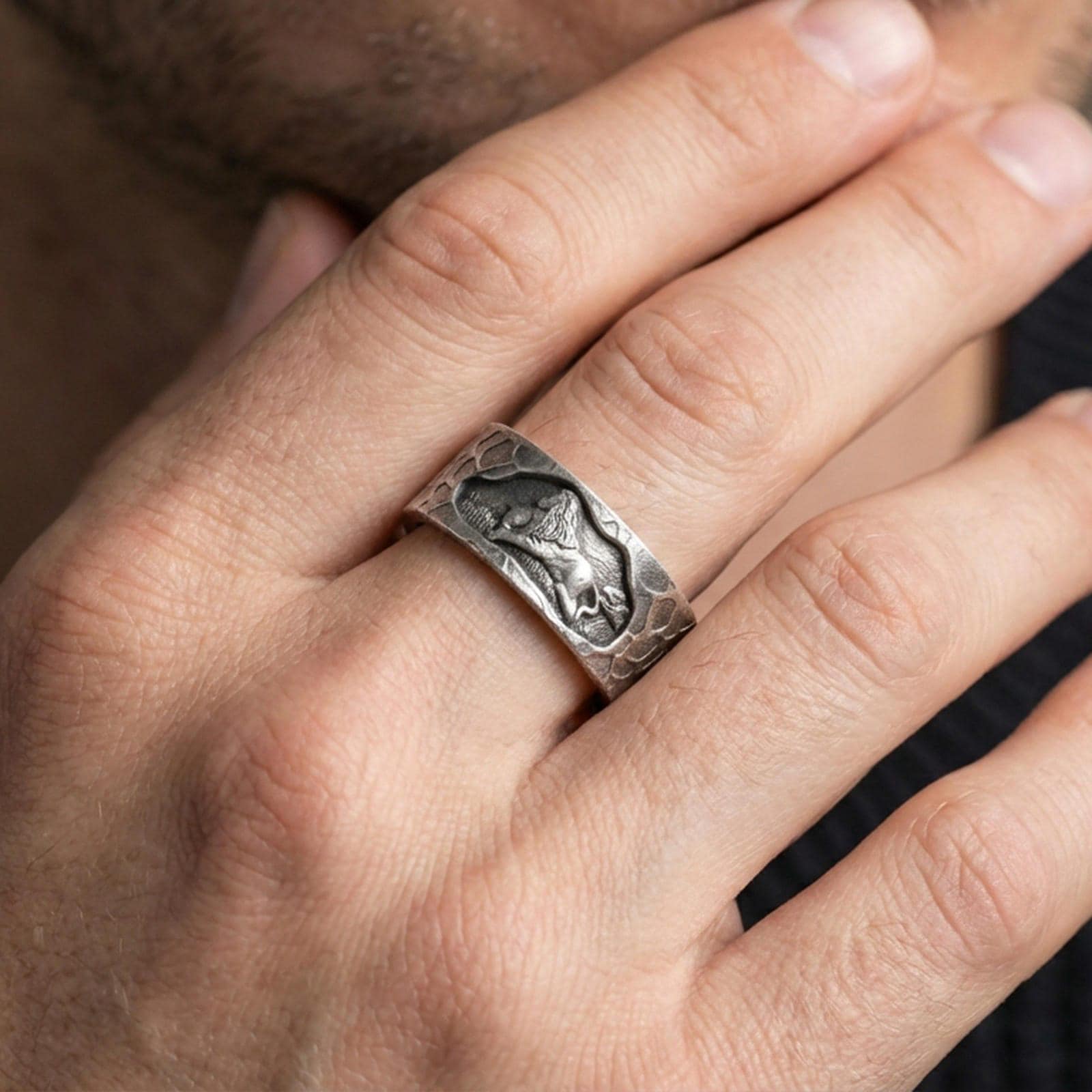 Oxidized sterling silver lion band ring worn on the finger, lifestyle image focusing on bold antique depth, lion symbolism of courage, and daily wear impact.
