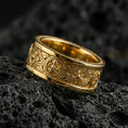 Load image into Gallery viewer, Gold plated spinner ring on volcanic stone, premium macro shot capturing warm gold tone across the Celtic pattern and textured relief details.
