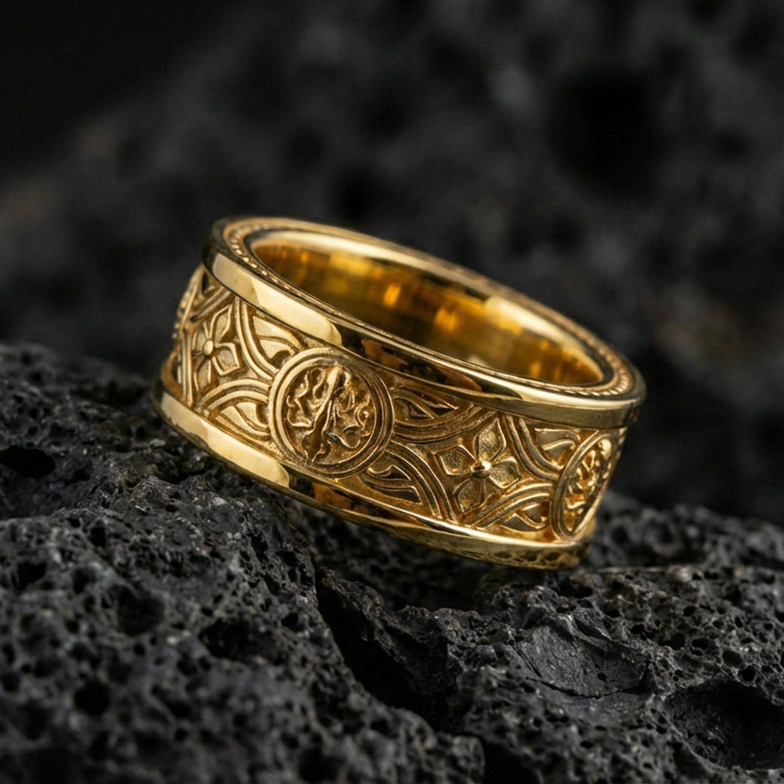 Gold plated spinner ring on volcanic stone, premium macro shot capturing warm gold tone across the Celtic pattern and textured relief details.