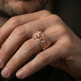 Load image into Gallery viewer, Rose gold plated lion head ring worn on the finger, lifestyle image showing elegant rose tone, sculpted lion detail, and premium statement look.
