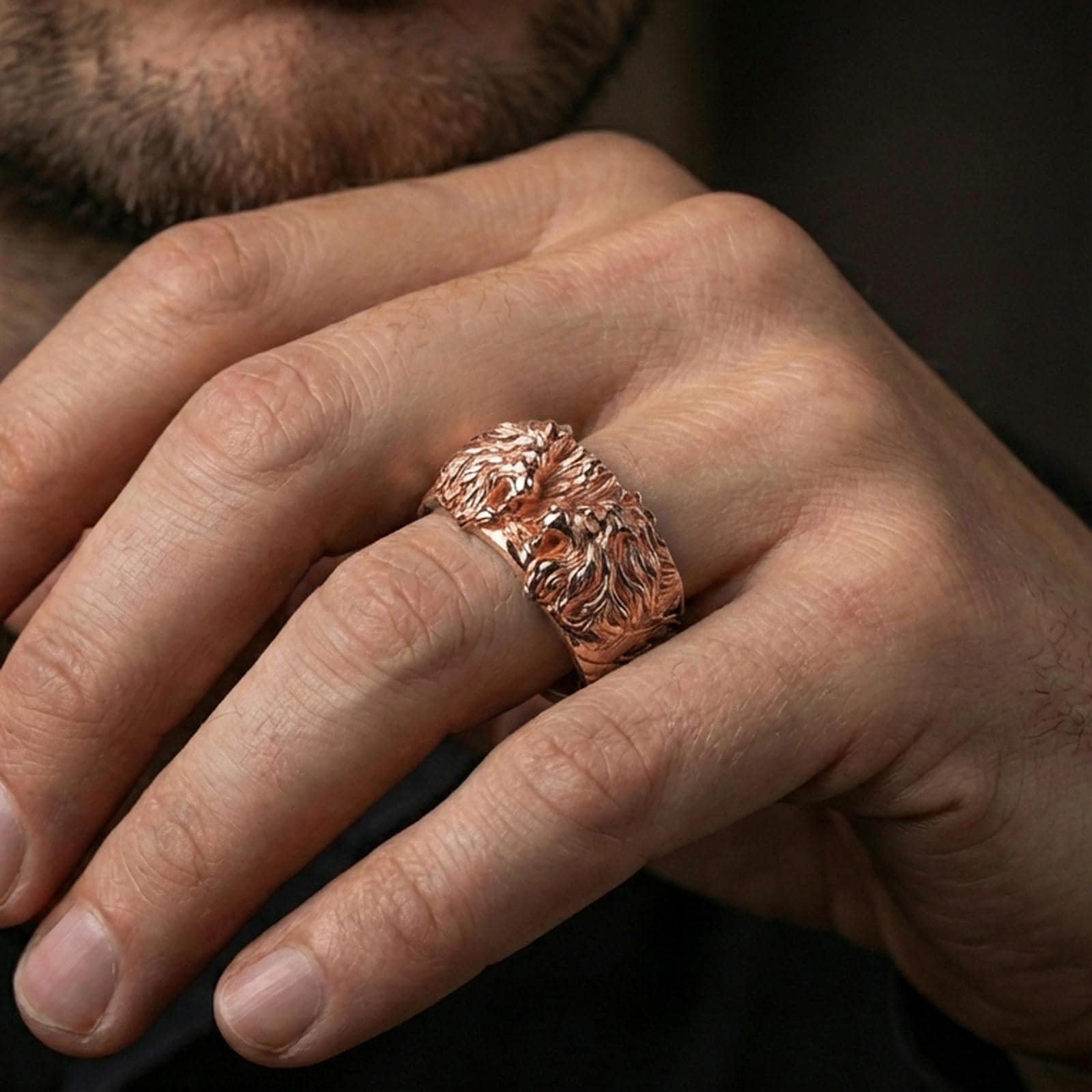 Rose gold plated lion head ring worn on the finger, lifestyle image showing elegant rose tone, sculpted lion detail, and premium statement look.