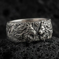 Load image into Gallery viewer, Oxidized sterling silver lion head ring on volcanic stone, macro close-up highlighting deep shadow contrast, roaring lion relief, and sculpted mane texture.
