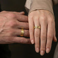Load image into Gallery viewer, Gold plated pebble texture band ring worn on the finger, lifestyle photo emphasizing luxury warmth, unisex stacking potential, and statement texture.
