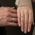 Load image into Gallery viewer, Rose gold plated pebble texture band ring worn on the finger, lifestyle image showing elegant rose tone, subtle sparkle on the pebble relief, and premium gift-ready appeal.
