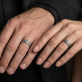 Load image into Gallery viewer, Oxidized sterling silver bark texture band ring worn on the finger, lifestyle image focusing on rustic minimal style, darkened depth, and everyday durability look.

