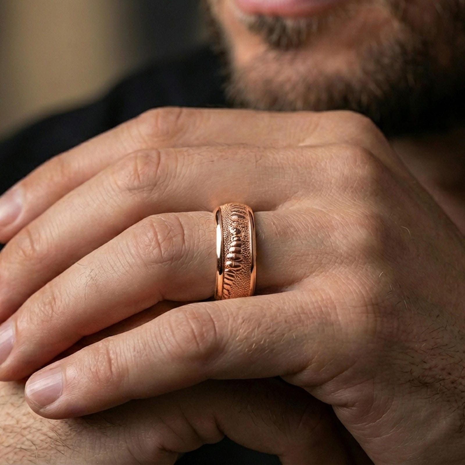 Rose gold plated lizard skin spinner ring worn on the finger, lifestyle image showing elegant rose tone, detailed scale relief, and a premium unisex spinner look.
