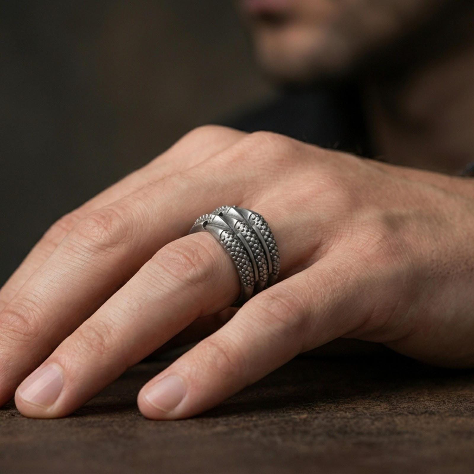 Oxidized sterling silver layered studded band ring worn on the finger, lifestyle image showing rugged industrial character and bold everyday presence.