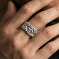 Load image into Gallery viewer, Polished silver dragon cloud band ring worn on the finger, lifestyle shot highlighting clean shine, dimensional scrollwork, and everyday statement styling.
