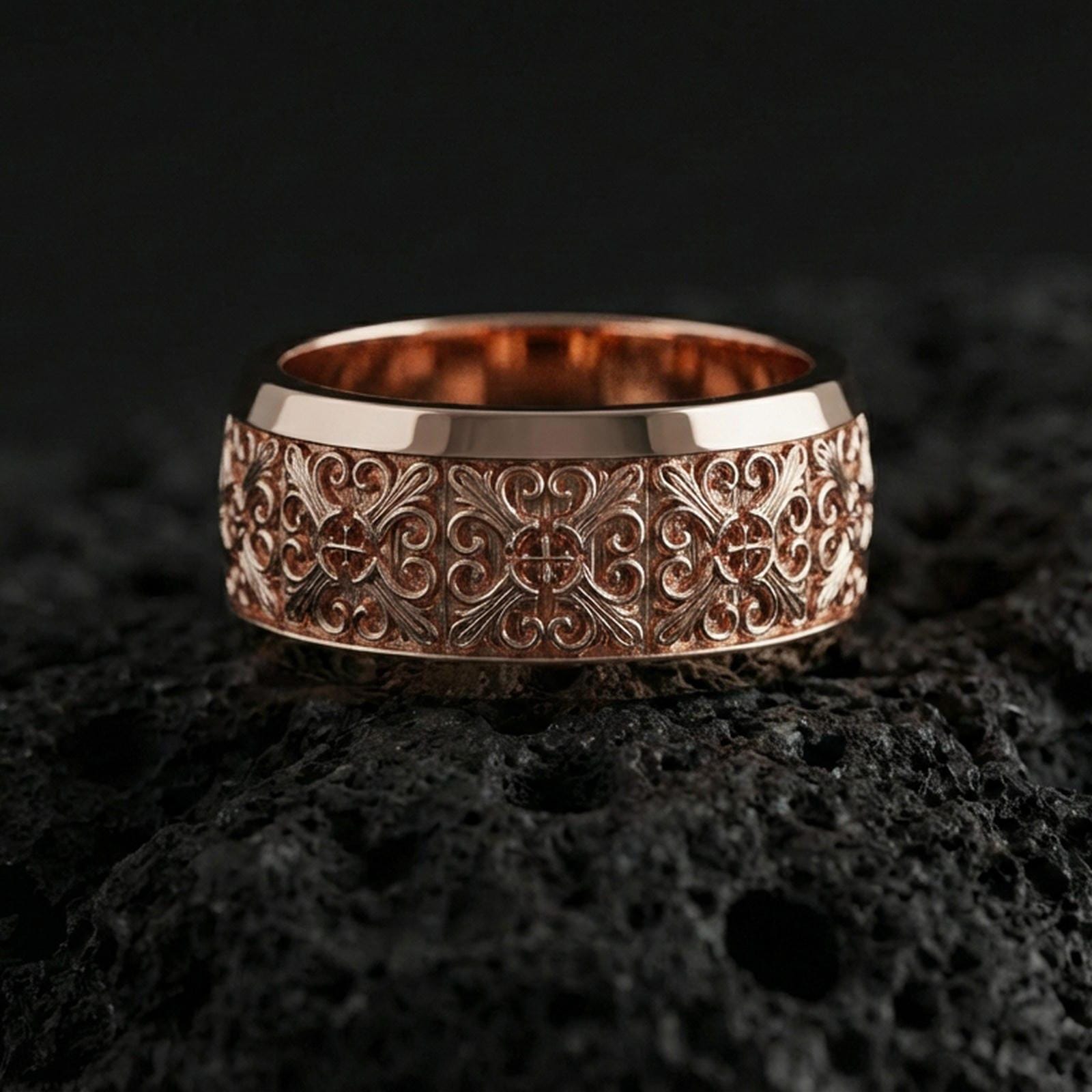 Rose gold plated cross scrollwork band ring on volcanic stone, refined macro close-up emphasizing soft rose warmth, intricate filigree curls, and centered cross elements.