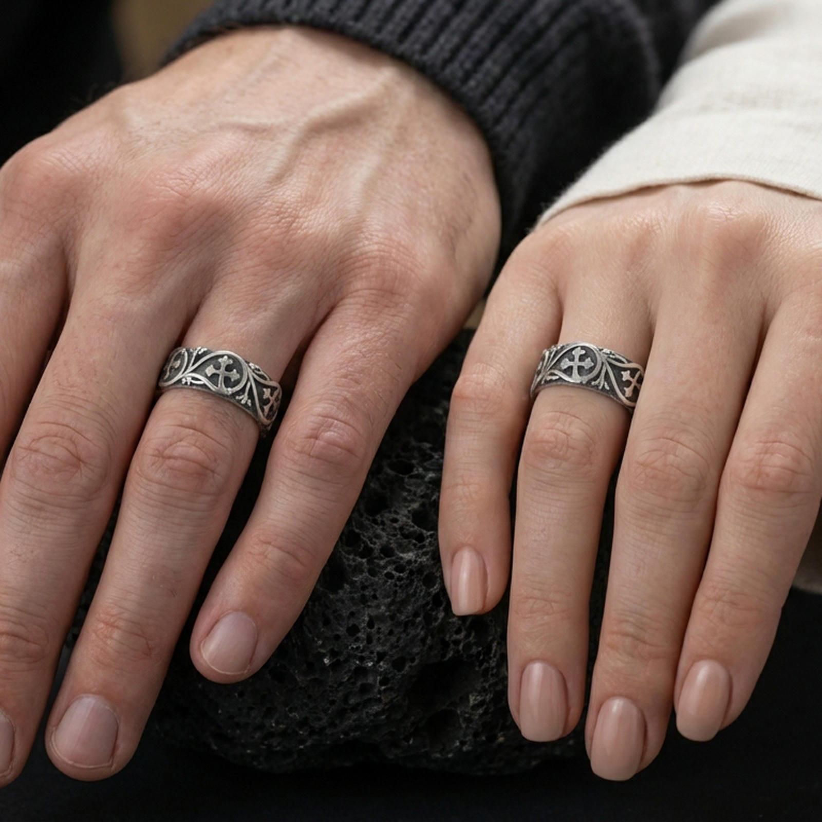 Oxidized sterling silver quatrefoil cross band ring worn on the finger, lifestyle image presenting bold contrast and a classic gothic-vintage look.