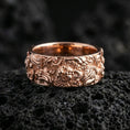 Load image into Gallery viewer, Rose gold plated guardian lion band ring on volcanic stone, refined macro close-up showcasing soft rose warmth, detailed lion expression, and dimensional carved background.
