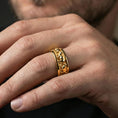 Load image into Gallery viewer, Gold plated horse band ring worn on the finger, lifestyle shot featuring rich gold glow and a standout running-horse motif with premium presence.
