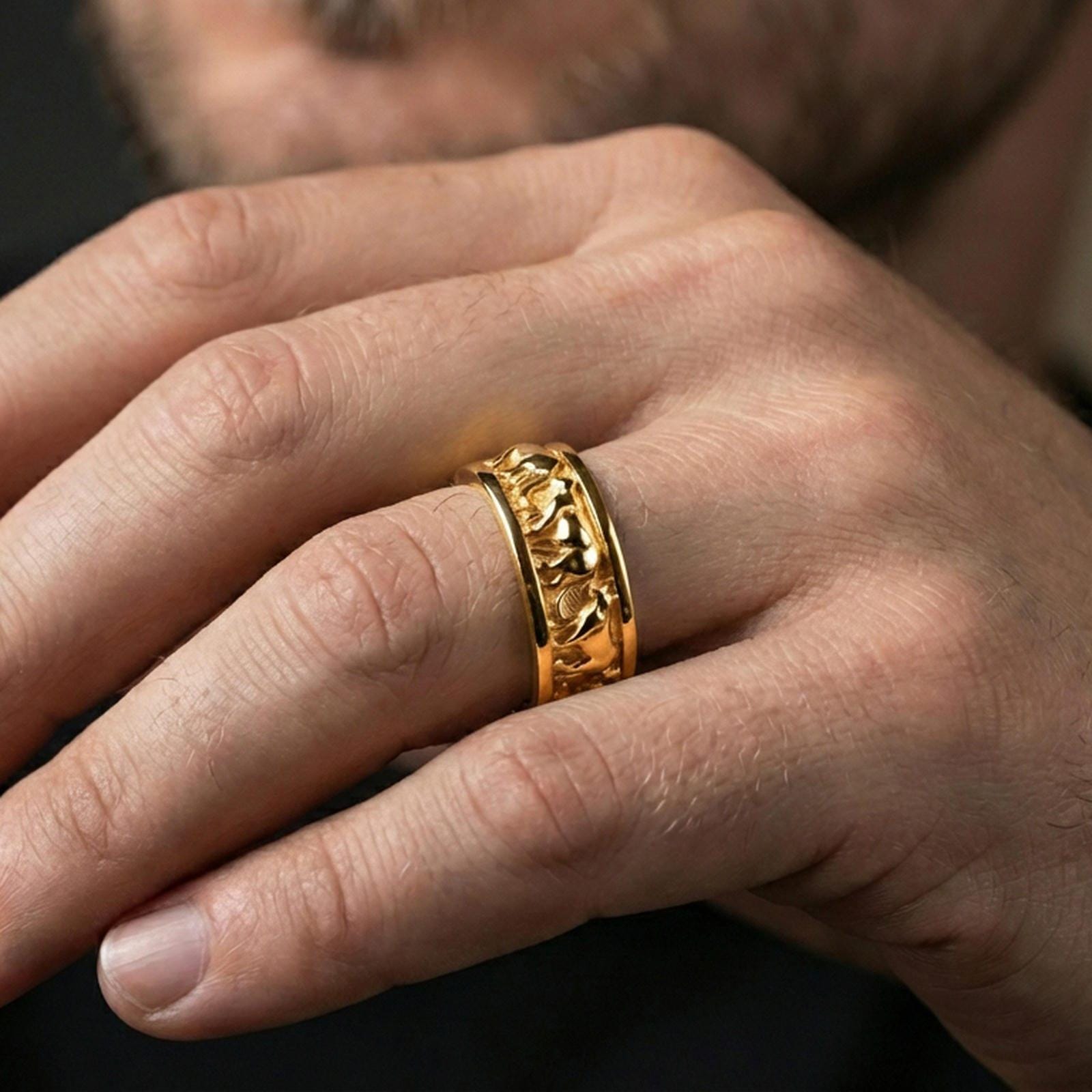 Gold plated horse band ring worn on the finger, lifestyle shot featuring rich gold glow and a standout running-horse motif with premium presence.