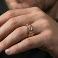 Load image into Gallery viewer, Rose gold plated horse band ring worn on the finger, lifestyle image highlighting elegant rose tone and the symbolic horse design for a distinctive gift.

