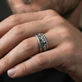 Load image into Gallery viewer, Oxidized sterling silver horse band ring worn on the finger, lifestyle image showing bold contrast, defined horse relief, and a rugged equestrian statement.
