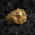 Load image into Gallery viewer, Gold plated skull signet ring featuring Celtic knot patterns on volcanic rock, premium macro shot emphasizing raised skull details and bright metallic shine
