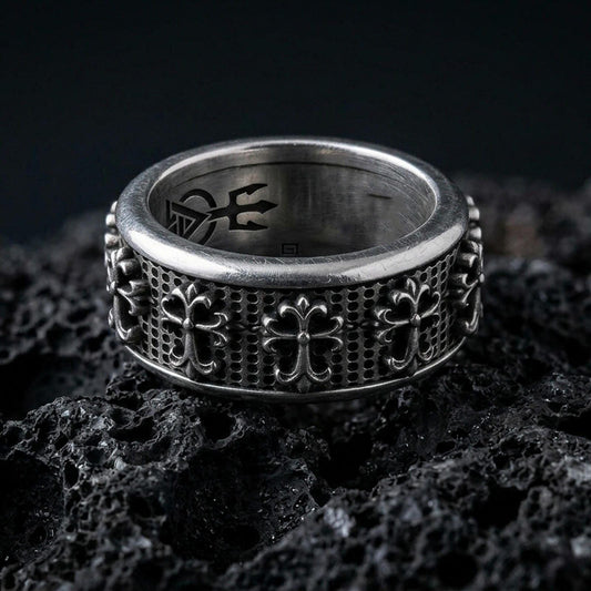 Gothic cross spinner ring on black volcanic stone, photographed in oxidized sterling silver with deep contrast highlighting the raised medieval crosses.
