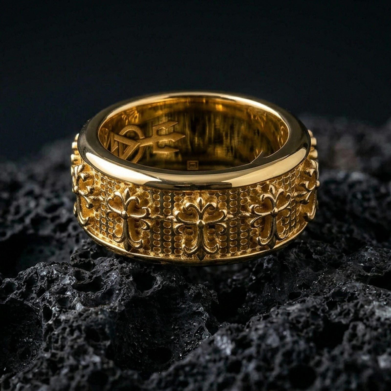 Gothic cross spinner ring on black volcanic stone, shown in a gold plated finish with warm shine emphasizing the gothic cross motifs and dotted texture.