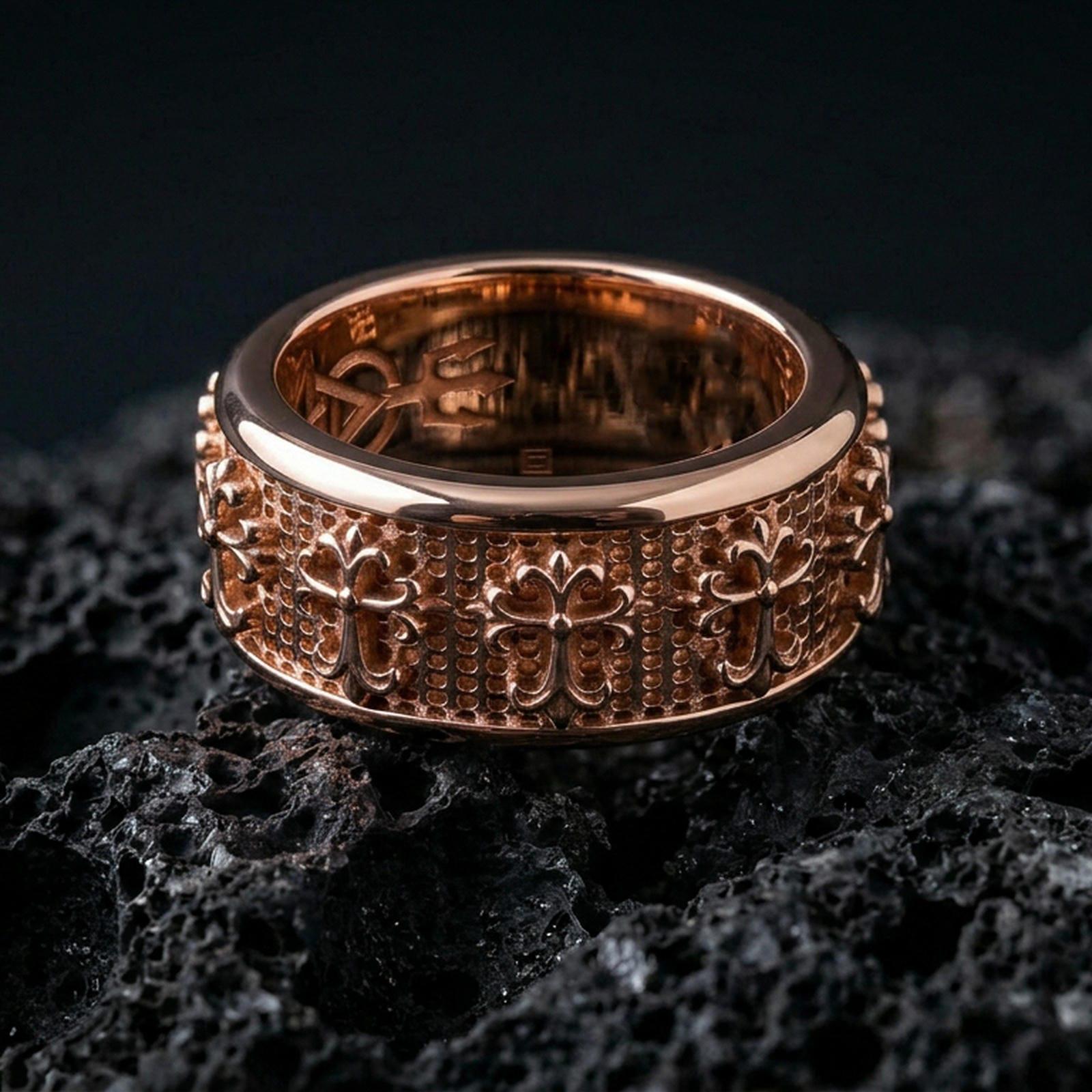 Gothic cross spinner ring on black volcanic stone, shown in a rose gold plated finish with a softer metallic glow across the medieval cross details.