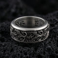 Load image into Gallery viewer, Ornate scrollwork sterling silver band ring on black volcanic stone, photographed with an oxidized finish to emphasize depth and shadow in the engraved pattern.
