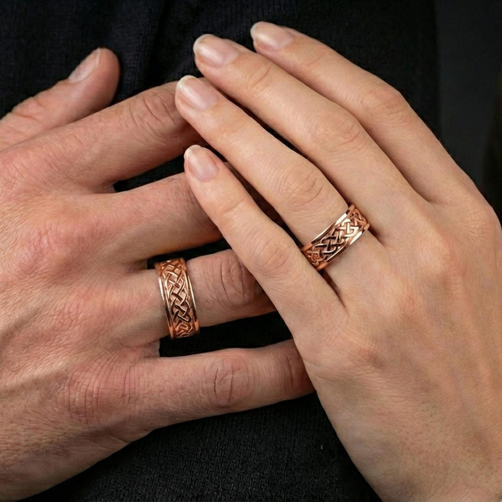 Sterling silver Celtic knot band ring worn on a finger, rose gold plated look with refined warmth and distinct knotwork relief for everyday styling.