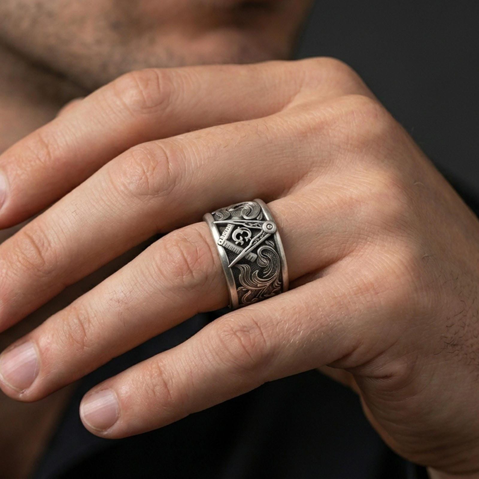 Sterling silver Masonic square and compass band ring worn on a finger, oxidized sterling silver look with strong contrast that keeps the symbol readable at a glance.