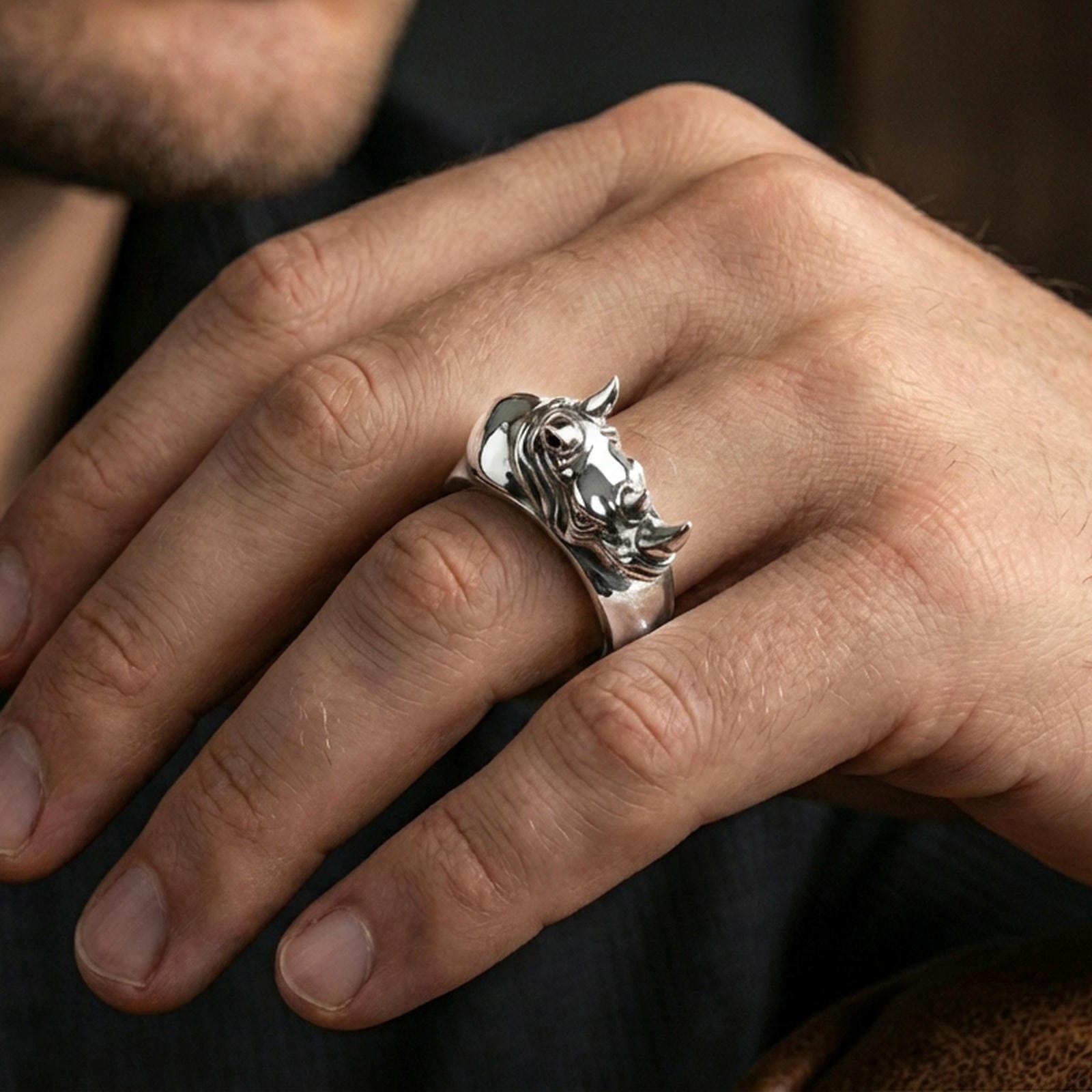 Sterling silver rhino head ring worn on a finger, polished silver finish delivering a clean reflective surface and crisp sculpted definition.
