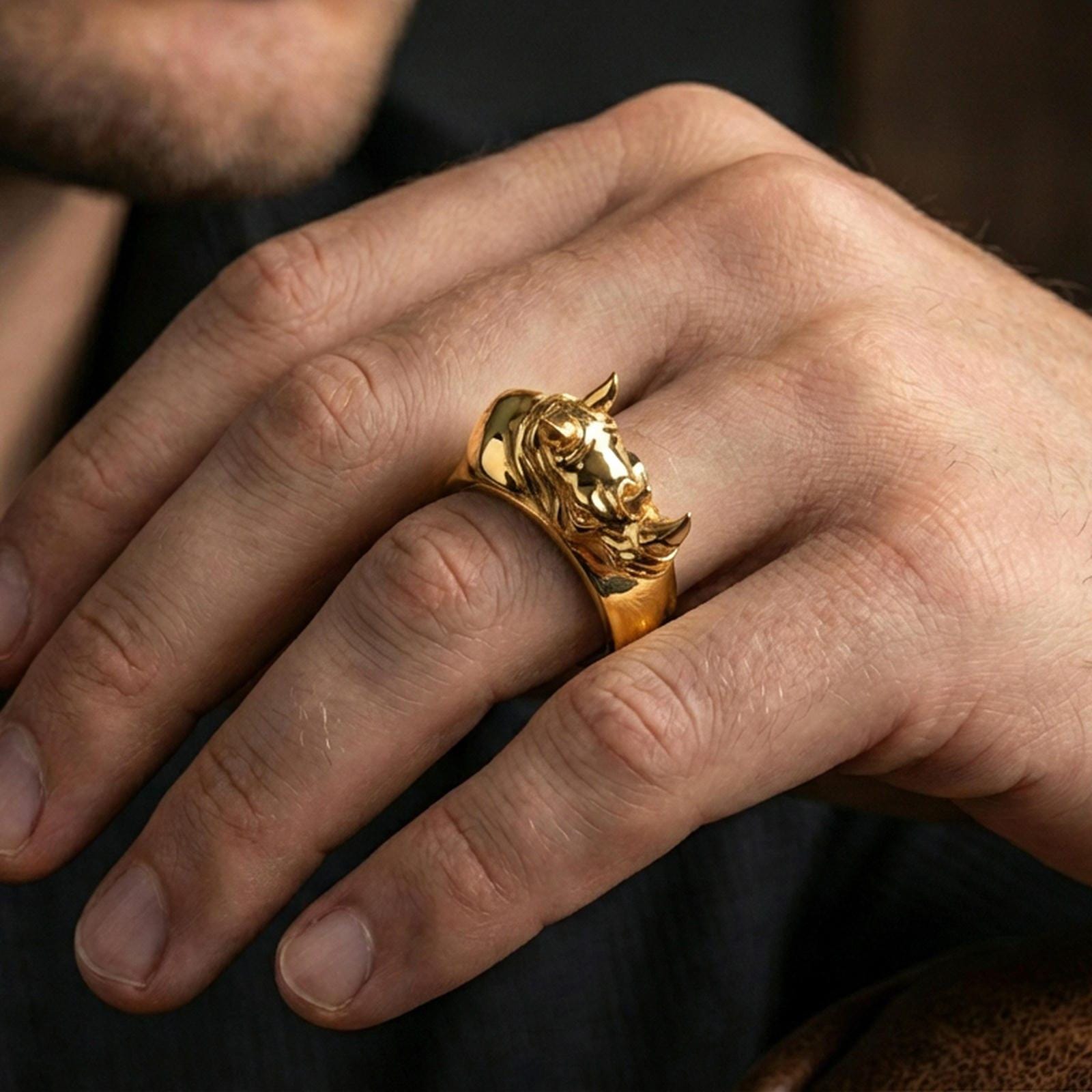 Sterling silver rhino head ring worn on a finger, gold plated finish creating a strong luxury look while keeping the rhino head contours sharp.