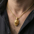 Load image into Gallery viewer, Gold plated boar head pendant necklace worn on the neck, lifestyle image emphasizing the bright finish and bold tusk detail
