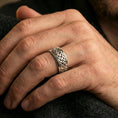 Load image into Gallery viewer, Celtic knot spinner band ring worn on a finger, polished silver finish with clean highlights and a modern, refined look.
