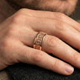Load image into Gallery viewer, Gothic fleur-de-lis band ring worn on a finger, rose gold plated finish with a smooth comfort-fit profile and elegant warm reflections.
