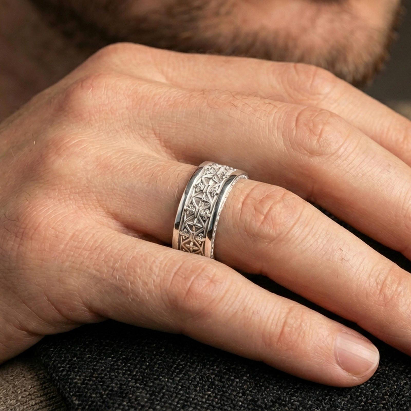 Gothic fleur-de-lis band ring worn on a finger, polished silver finish with clean highlights and a refined classic look.