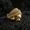 Load image into Gallery viewer, Gold plated skull ring with beanie and goggles on volcanic rock, premium macro shot emphasizing high-relief street style design and bold shine

