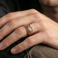 Load image into Gallery viewer, Angel wing sterling silver band ring worn on a finger, rose gold plated finish with elegant warm tones and detailed feather contours.
