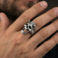 Load image into Gallery viewer, Oxidized openwork skull ring worn on a finger, lifestyle close-up showing gothic statement style and dramatic negative space design
