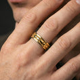 Load image into Gallery viewer, Industrial tread pattern sterling silver spinner ring worn on a finger, gold plated finish for a bold statement with high-contrast angles.
