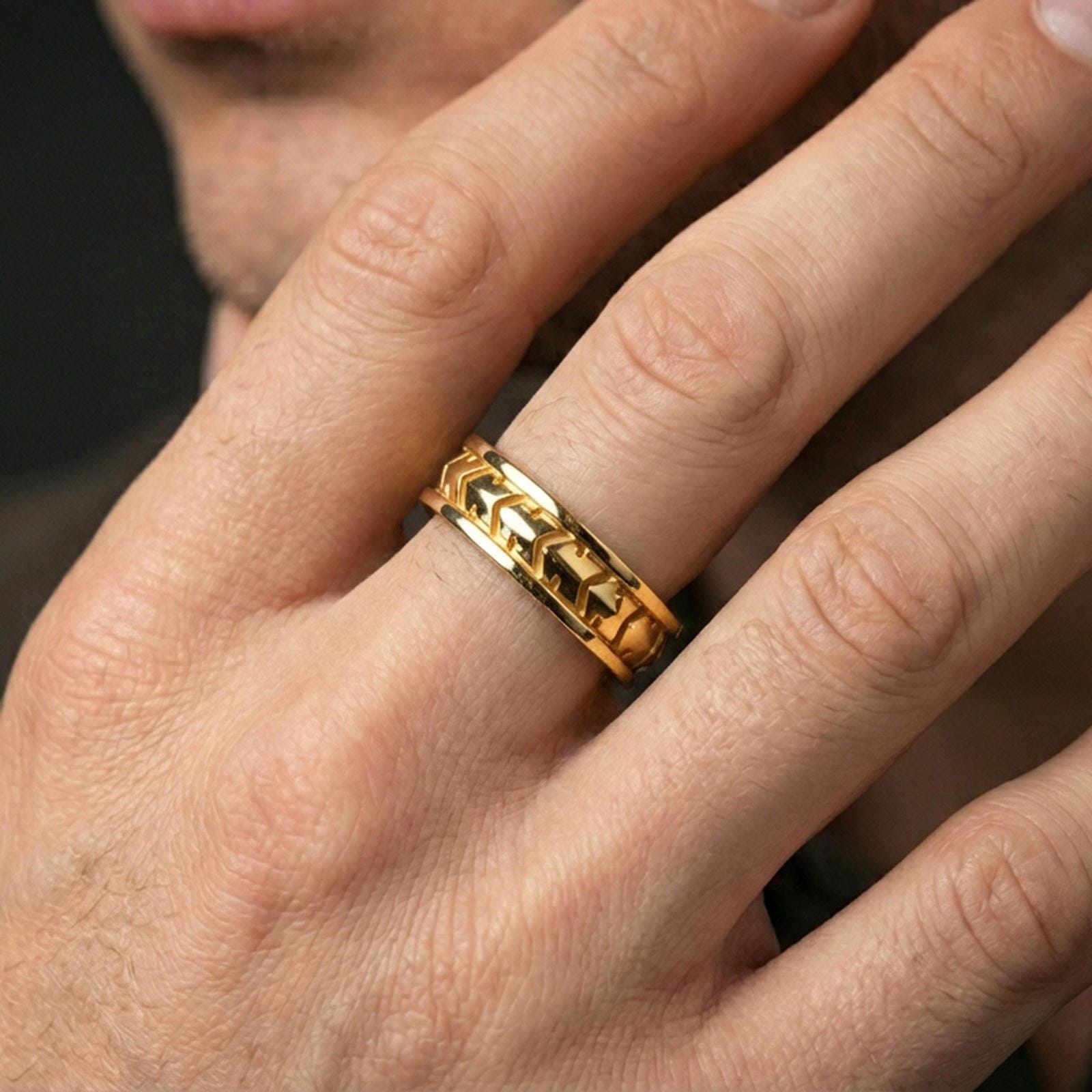 Industrial tread pattern sterling silver spinner ring worn on a finger, gold plated finish for a bold statement with high-contrast angles.